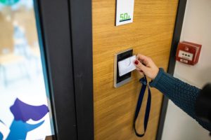 staff member using ID enter key to open the door at the building